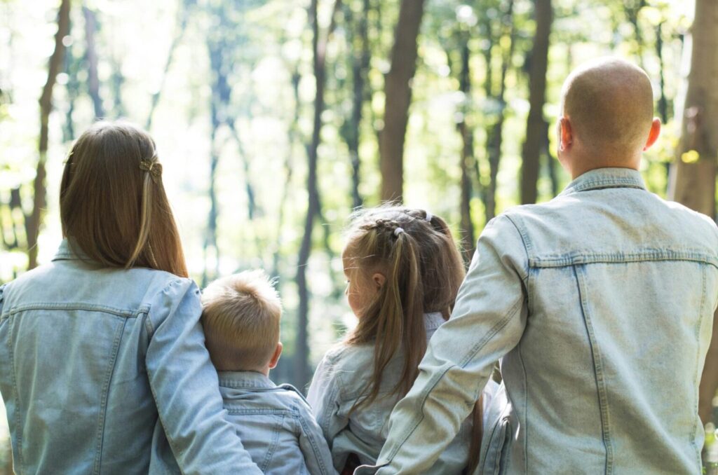 Family sitting in the woods